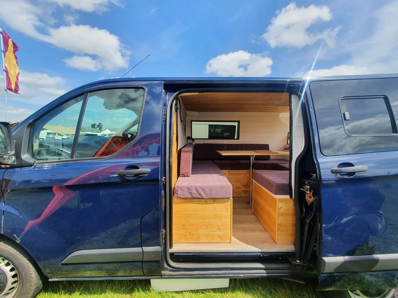 Luna. U shaped seating, Extra large king sized bed, Rear kitchen, Off-grid, Gas free, Induction hob, Fridge. Photo 9 of 12.