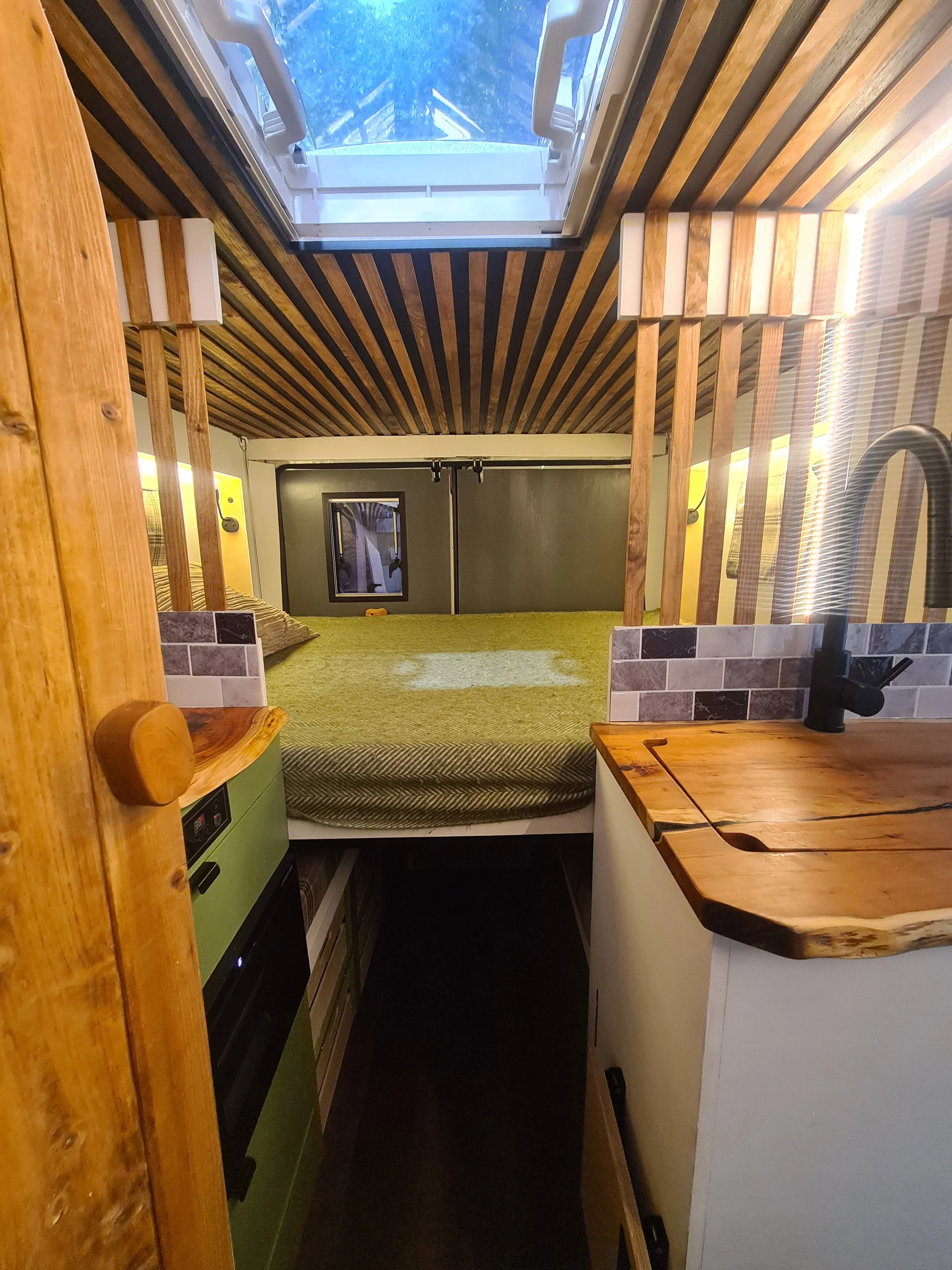SWB Fiat Ducato. Fully off grid, Gas free, Lifting bed, Seating for 4, Live edge yew table, Kitchen, Full height wardrobe, Composting toilet. Photo 5 of 22.