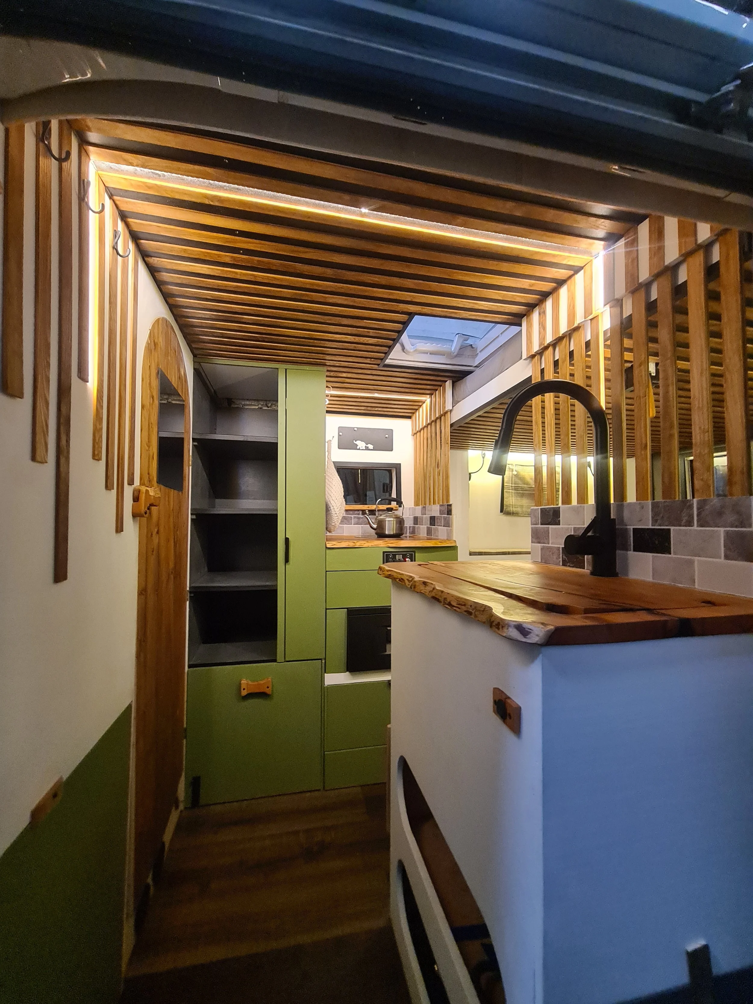 SWB Fiat Ducato. Fully off grid, Gas free, Lifting bed, Seating for 4, Live edge yew table, Kitchen, Full height wardrobe, Composting toilet. Photo 13 of 22.
